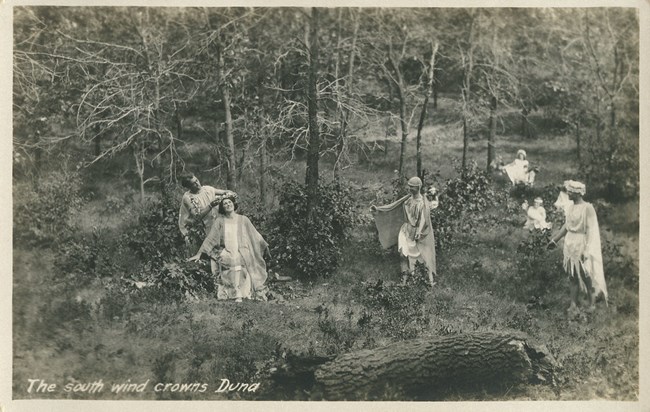 Historic sepia photograph from 1913 of a masque performance in the Indiana Dunes.