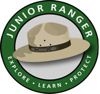 logo with the words Junior Ranger on a green ring and ranger hat inside that ring