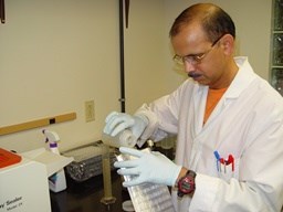 U.S.G.S. scientist conducts laboratory analysis of water samples.