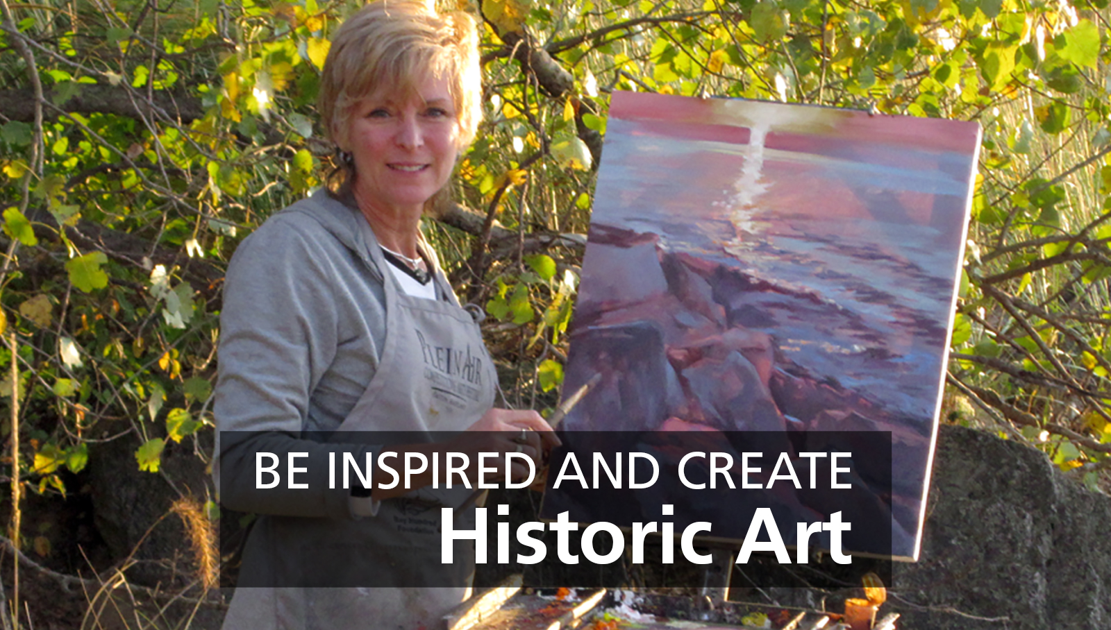 Artist-in-Residence Nancie King Mertz Banner 2024 2011 Artist-in-Residence Nancie King Mertz in the field next to a painting of the lakefront during a sunset.