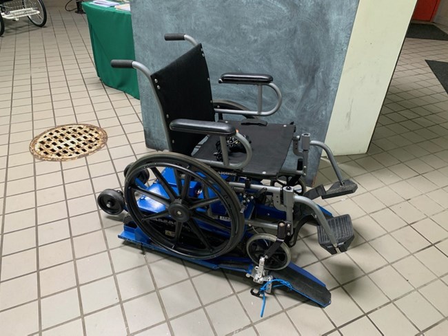 A motorized dual track wheel chair attachment.