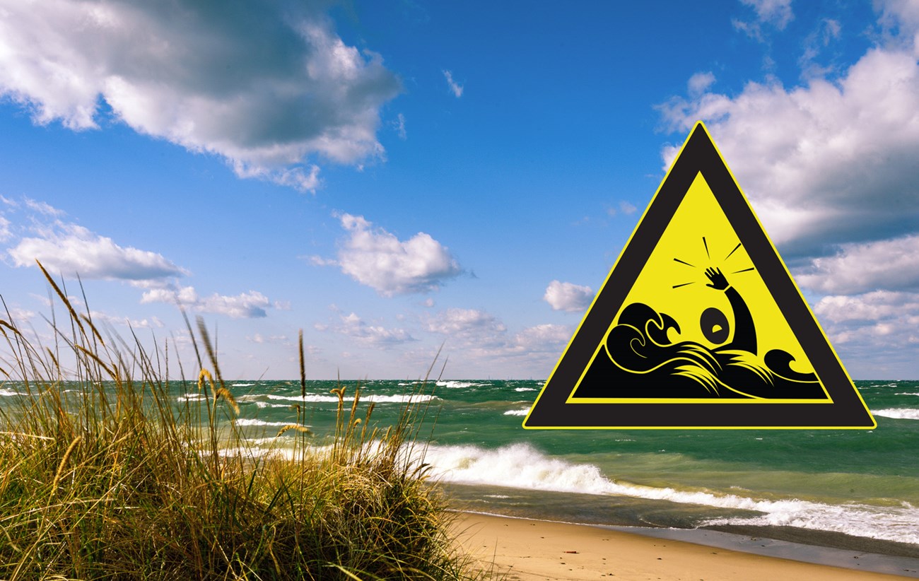 Rip current warning sign on beach photo.
