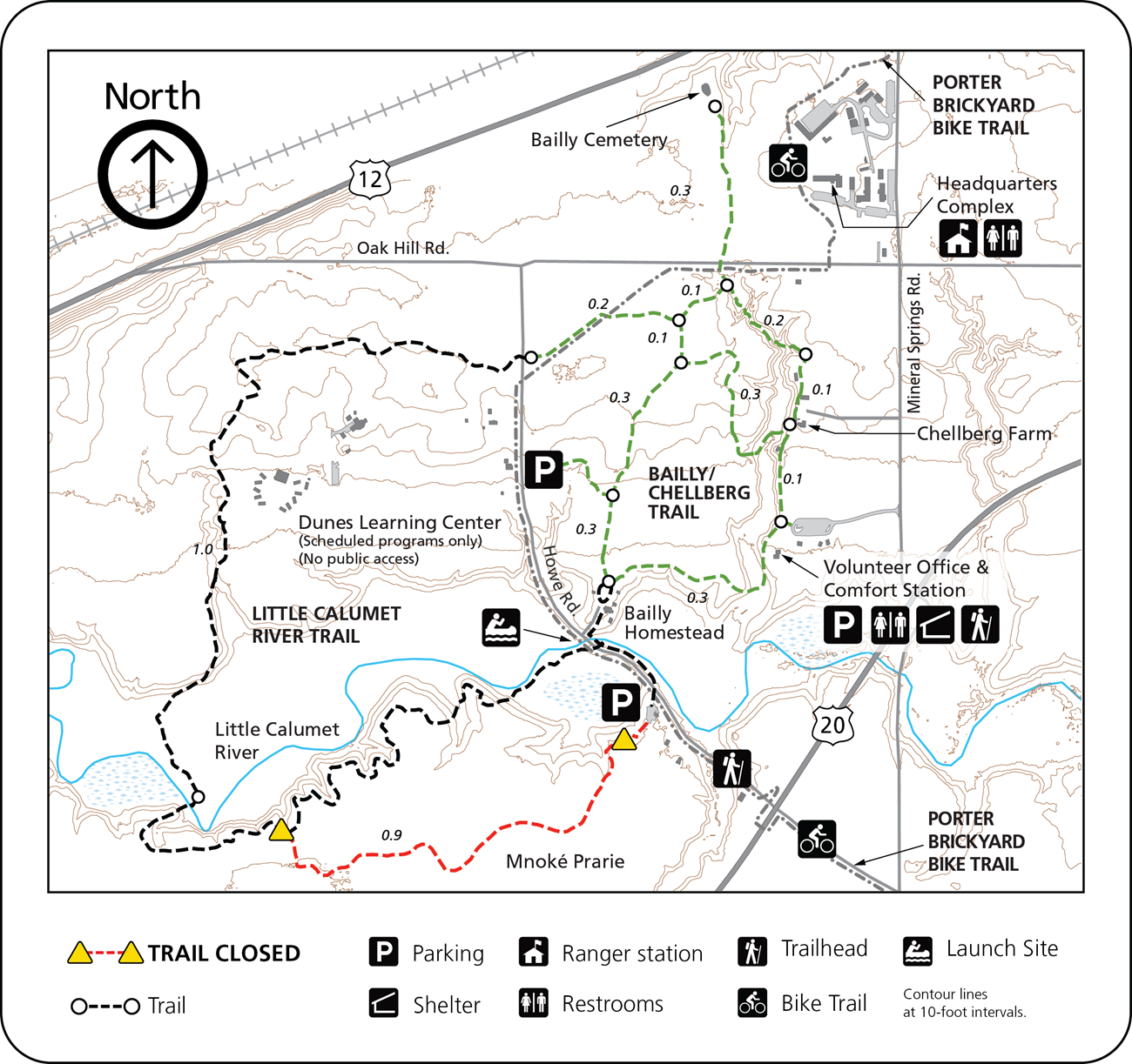The Bailly/Chellberg Trail map shows labeled trails, landmarks, amenities, contour lines, and key sites with a legend for parking, stations, and trail types. North is at the top; trails and closures are clearly marked.