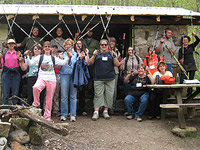 people at a camp, with hiking gear, looking at the camera