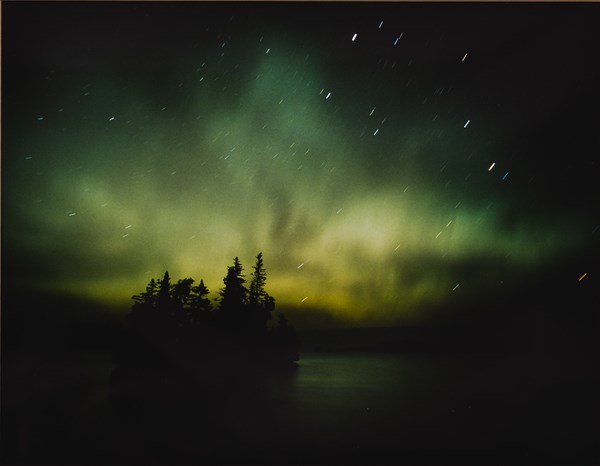 A photograph shows the night sky with northern lights
