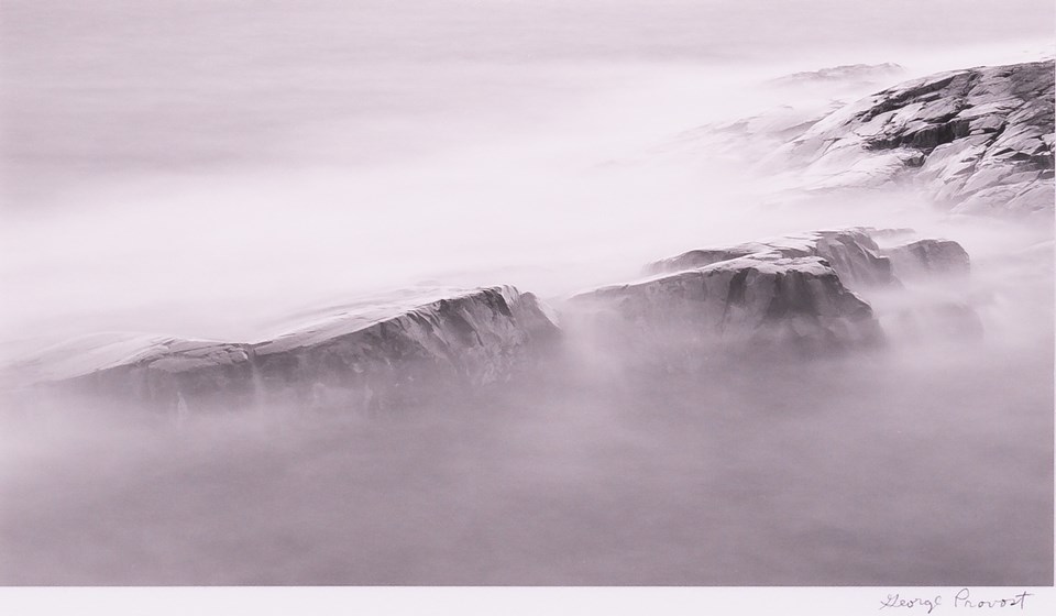 Artwork shows waves over rock in fog