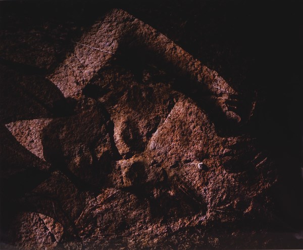 An artist's work shows an overlay of a human on top of a rock