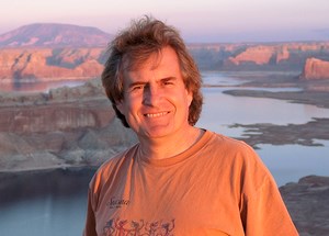 A photo of a man with a scenic background