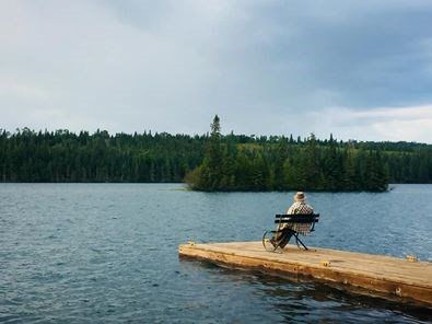 Keith Taylor sitting on a dock at Isle Royale