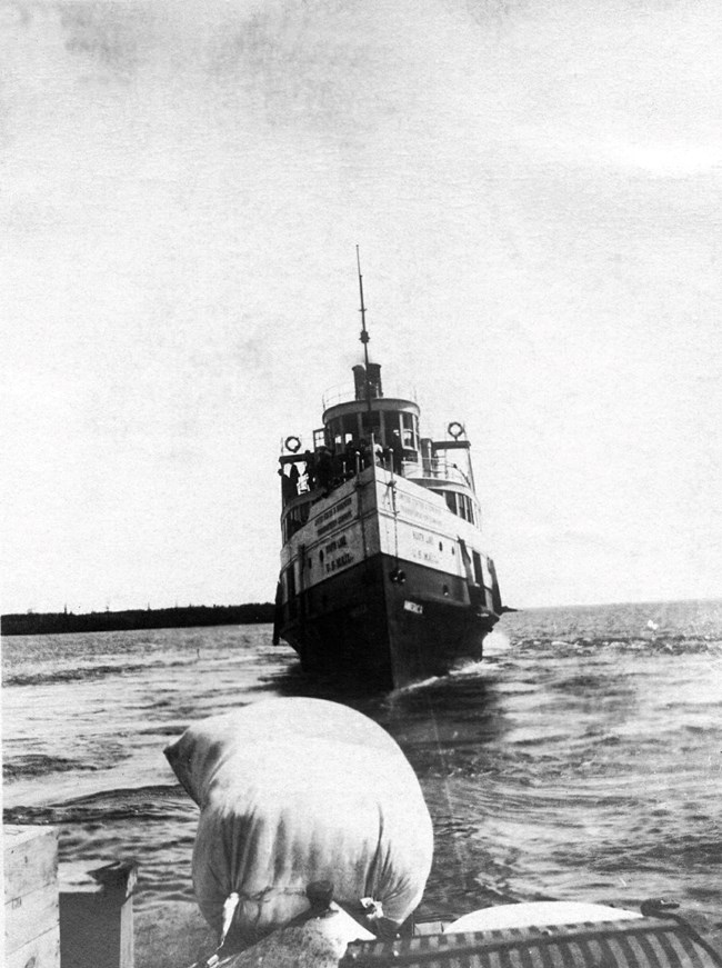 SS America in black and white out on open water sailing with bow towards photographer