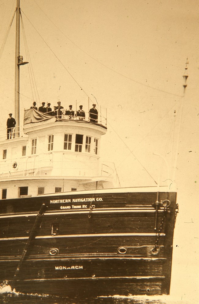 crew and bow of the SS Monarch under power