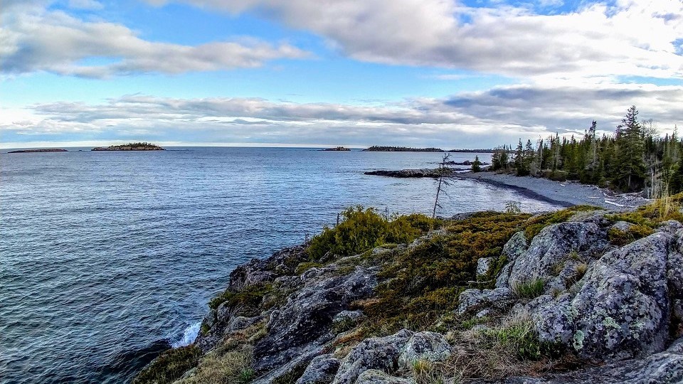 view of Rock Harbor channel rocky shoreline from overlooking cliff