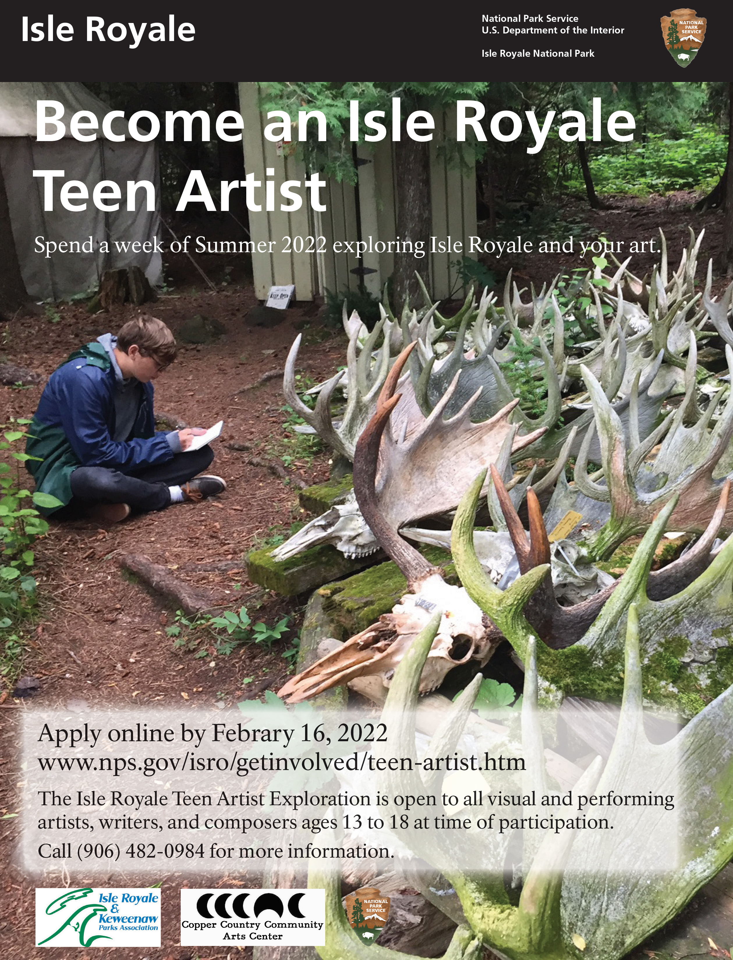 Teen artist sitting on the ground sketching. Moose antlers are arranged in racks in front of him.