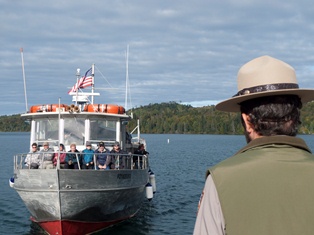 A ranger greets visitors arriving on the Voyageur II ferry. A ranger greets visitors arriving on the Voyageur II ferry.