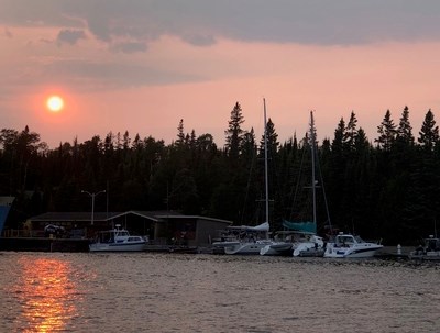 A marina with several boats at sunset