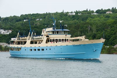 The Ranger III ferry providing a Keweenaw Waterway Cruise along the Portage Canal. Passengers stand on the second deck.