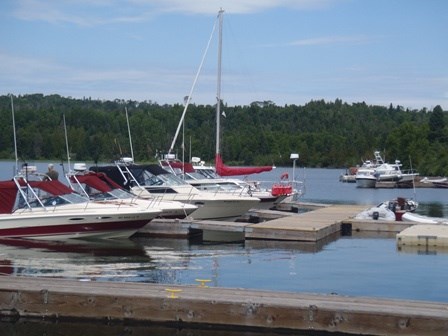 Powerboats and sailboats docked.