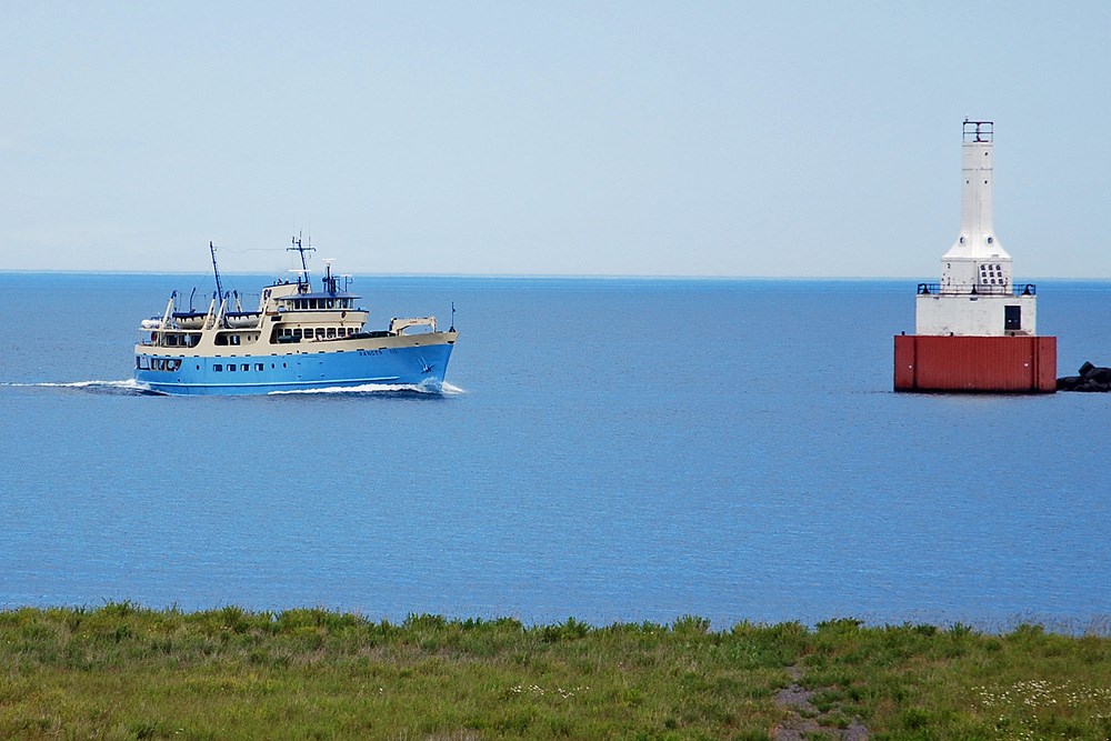 Ranger III ferry entering the north entry of the Keweenaw Waterway next to the lighthouse.