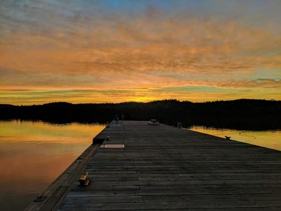 A photo taken from a large dock at sunset