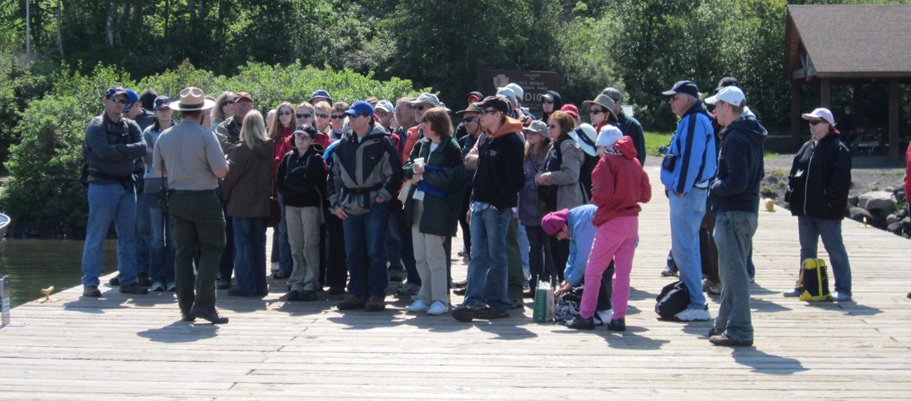 Visitors attend a ranger program at the Windigo dock