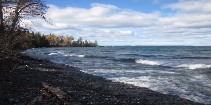Waves crash into a rock shoreline on the north shore of Isle Royale National Park. Waves crash into a rock shoreline on the north shore of Isle Royale National Park.