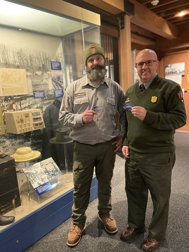 two rangers holding their veterans passes