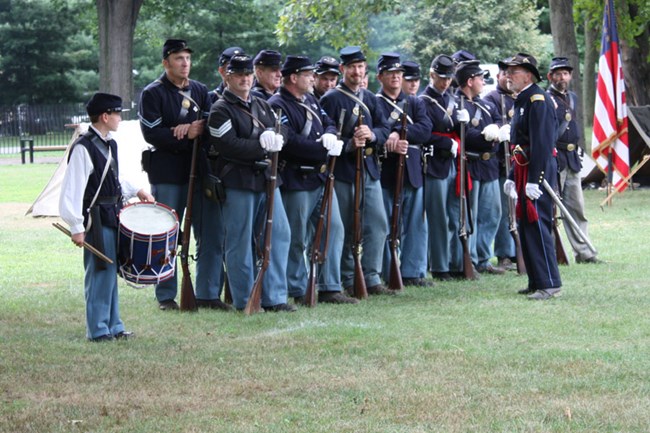 Soldiers awaiting orders. Picture of Civil War reenactors standing at attention waiting for orders from their commander.