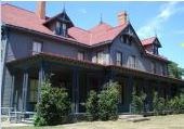 the home is gray with a red roof