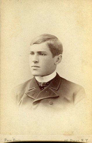 a photo that is brownish in color of a boy wearing a suit jacket