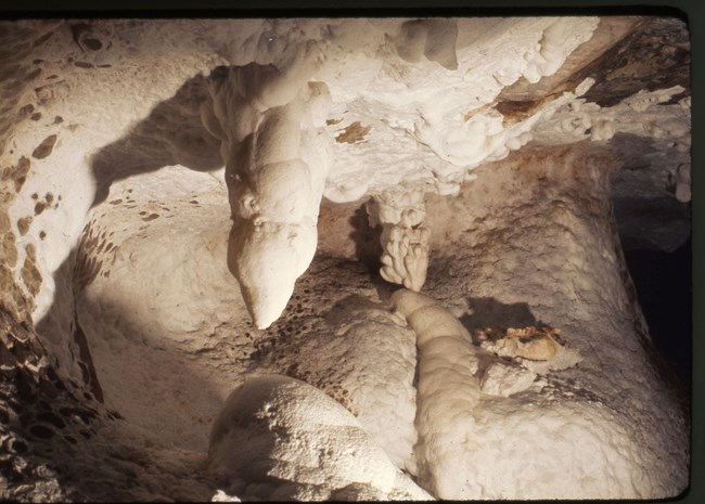 A room of Jewel Cave with a white coating of moonmilk over various formations