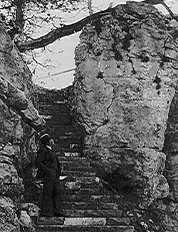 Man standing at the base of the stone staircase built by the CCC for Jewel Cave National Monument.