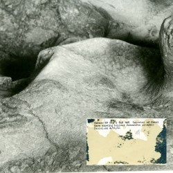 Historic image of a mound of calcite, with the back of the image displayed in the bottom right corner.