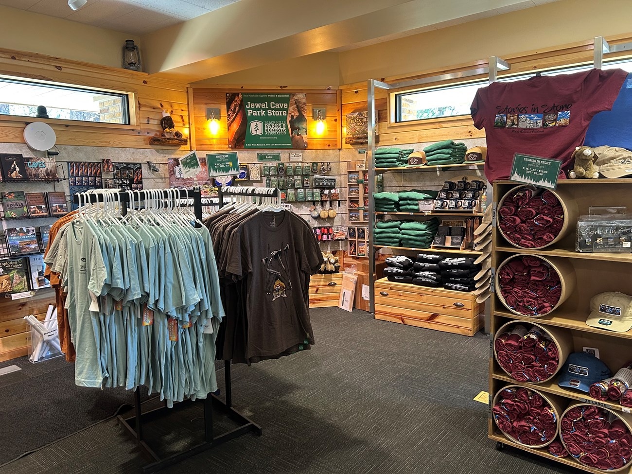 Interior of the park store with wooden shelves displaying books, plush animals, and souvenirs.