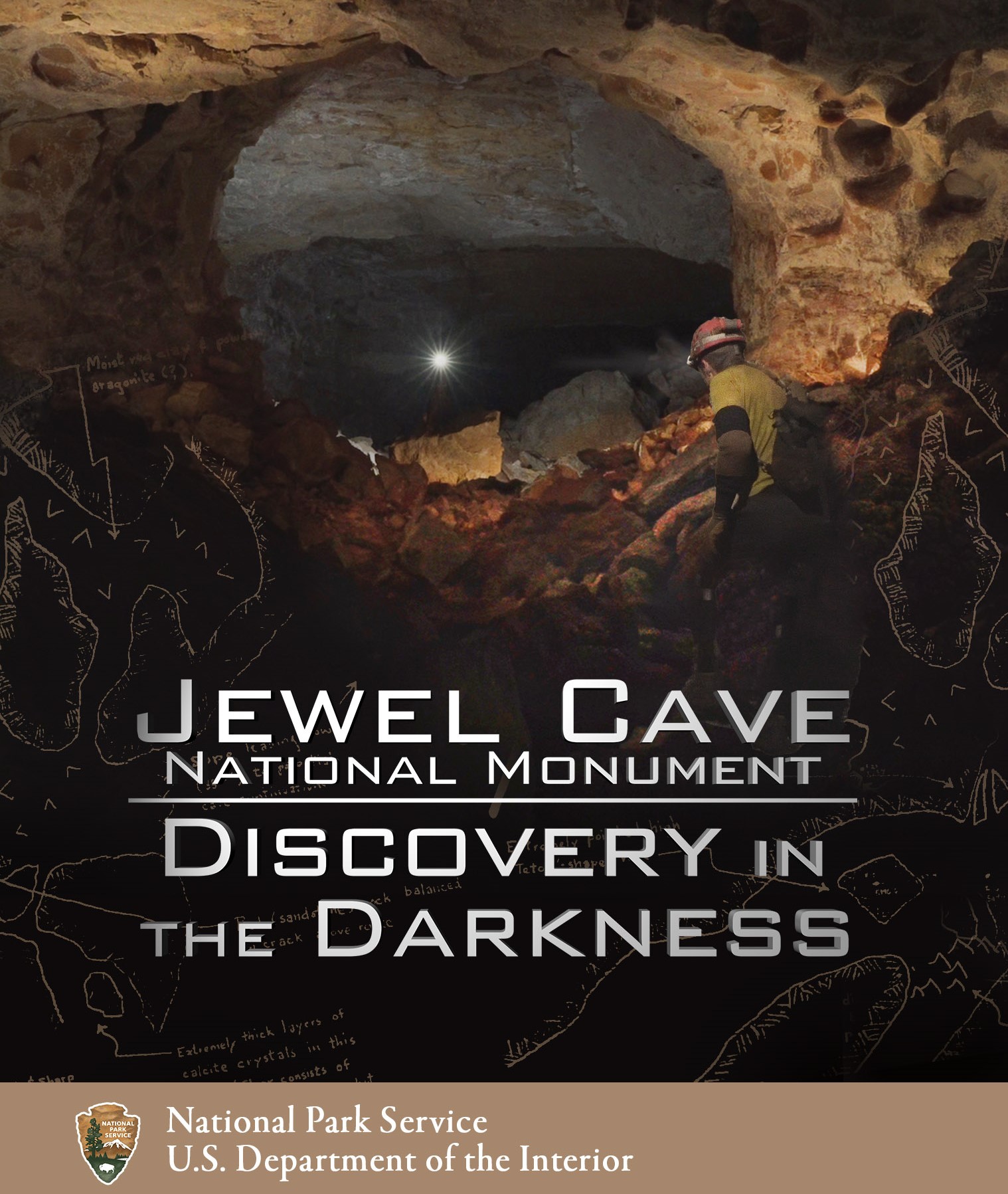 The DVD cover art for the park film showcases a cave explorer, one of the highlights of the movie. A caver is looking into a large opening. In the black areas are the words Jewel Cave National Monument: Discovery in the Darkness. At the bottom of the image is an arrowhead and the words National Park Service and U.S. Department of the Interior.
