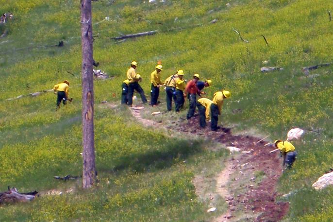 A Department of Agriculture Job Corps crew digs a trench for a new fiber line at Jewel Cave National Monument as part of the Service First Agreement.