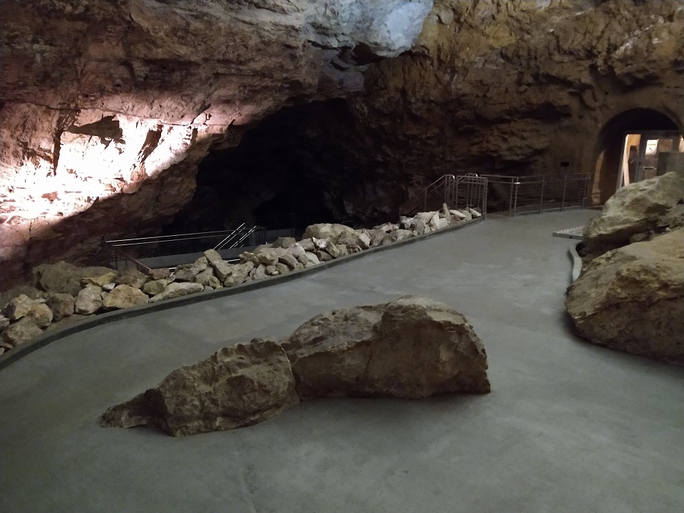 Target Room at Jewel Cave NM large rock in a concrete platform of a dark cave room