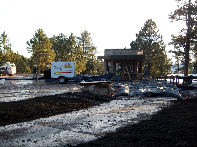 Photo of parking lot and sidewalk construction in progress, with new ticket kiosk in the background.