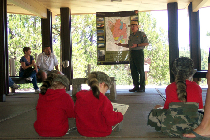 A park ranger conducts a Special Junior Ranger Programs for numerous guests near the visitor center.