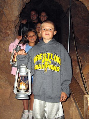 A family enjoys the Historic Lantern Tour route in Jewel Cave. This tour is offered only during the summer months. A family enjoys the Historic Lantern Tour route in Jewel Cave. This tour is offered only during the summer months.