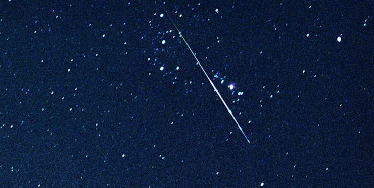 Streak of light just below Orion's belt, caused by a Perseid Meteor burning up in Earth's atmosphere.