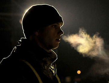 man in ski cap A man wearing a ski hat is seen, with a cloud forming his breath.