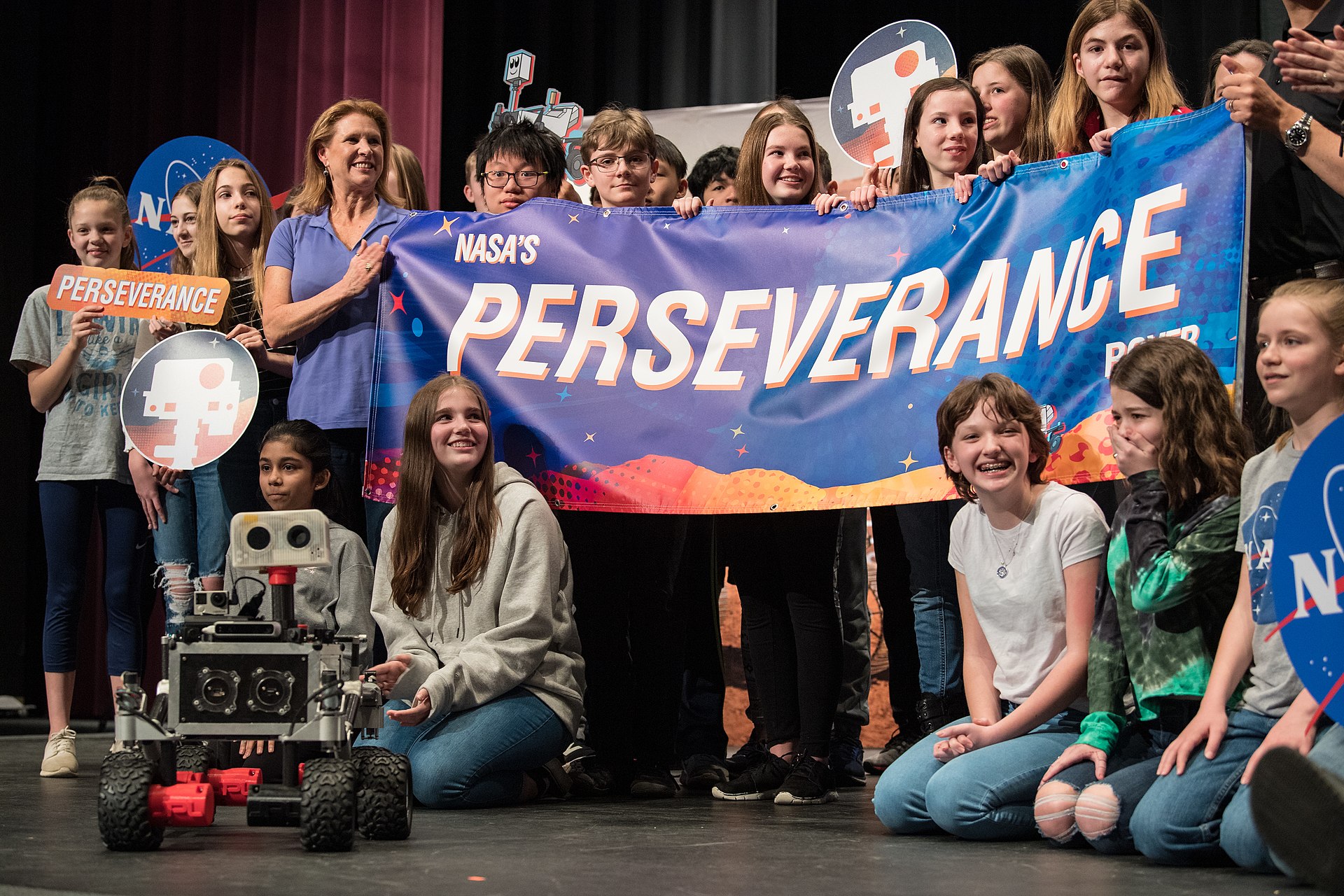 Group of elementary students holding banner that reads Perseverence Group of elementary students holding banner that reads Perseverence