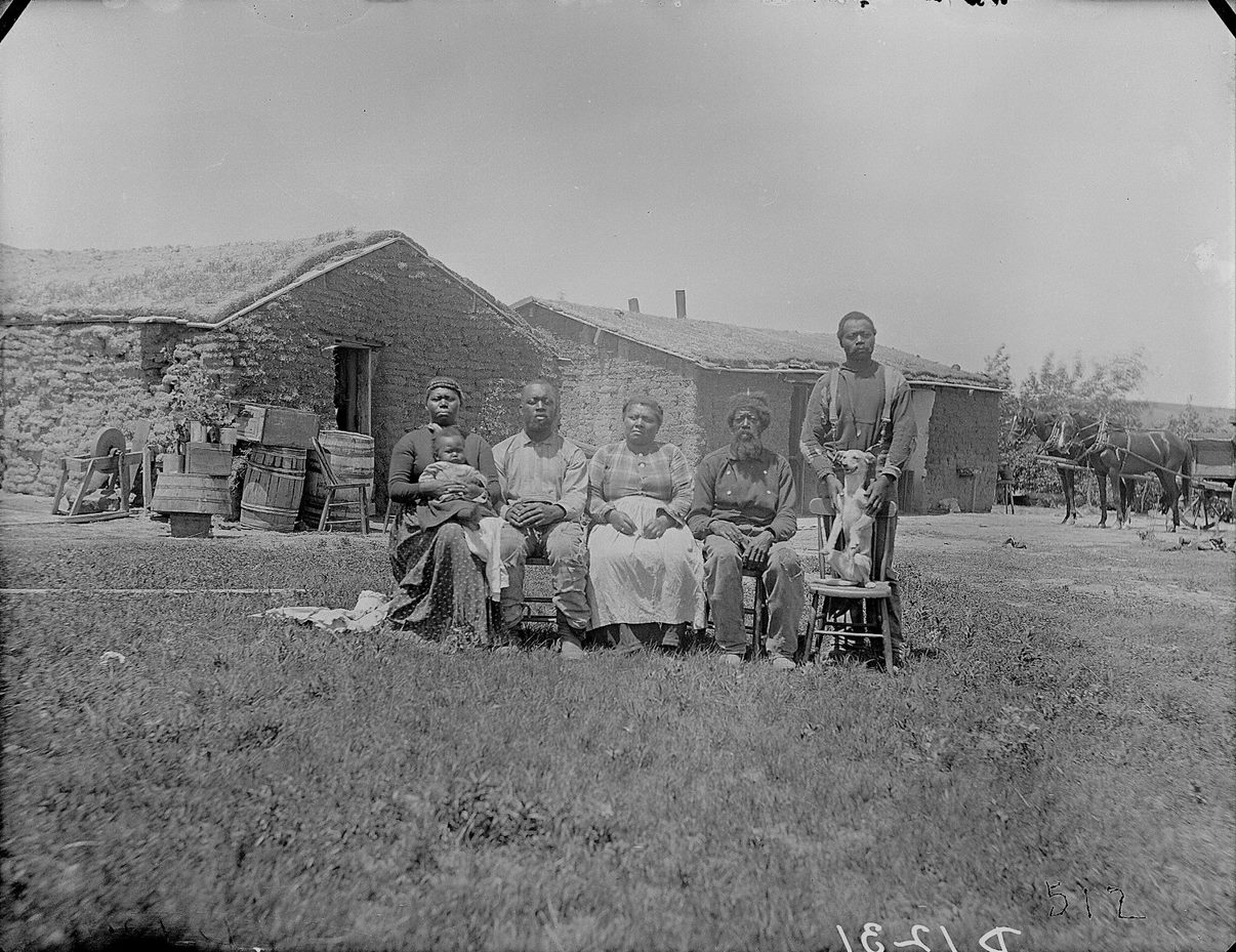 Shore family in front of their sod house