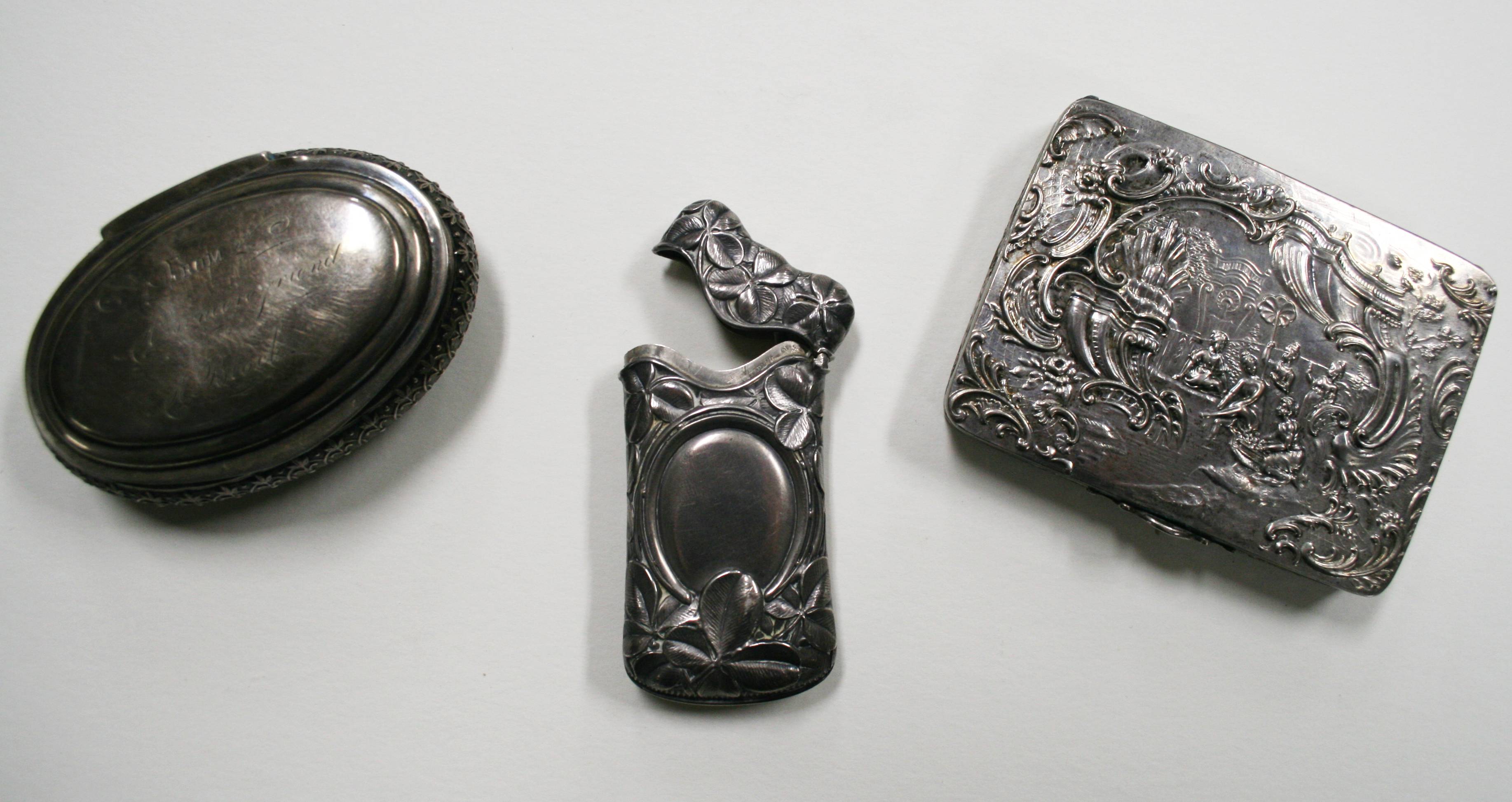 three silver compact cases