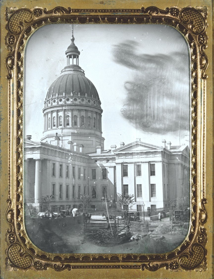 black and white photo of two story marble structure with copper dome.