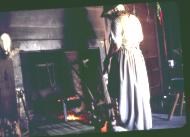 woman cooking at fireplace
