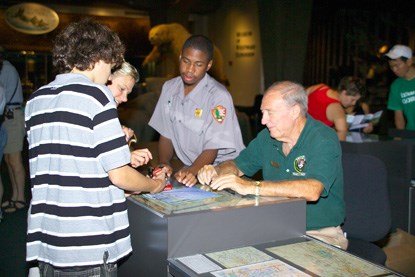 Volunteer giving information to a visitor at the Gateway Arch Visitor Center