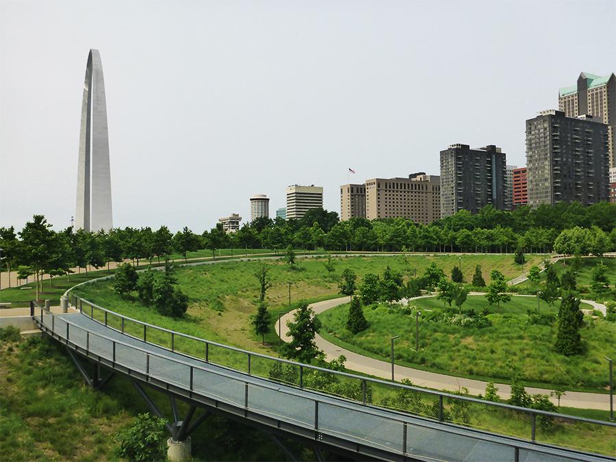 Gateway Arch in the left background, green space of the North Gateway and curving raised walkway in the foreground. Gateway Arch in the left background, green space of the North Gateway and curving raised walkway in the foreground.