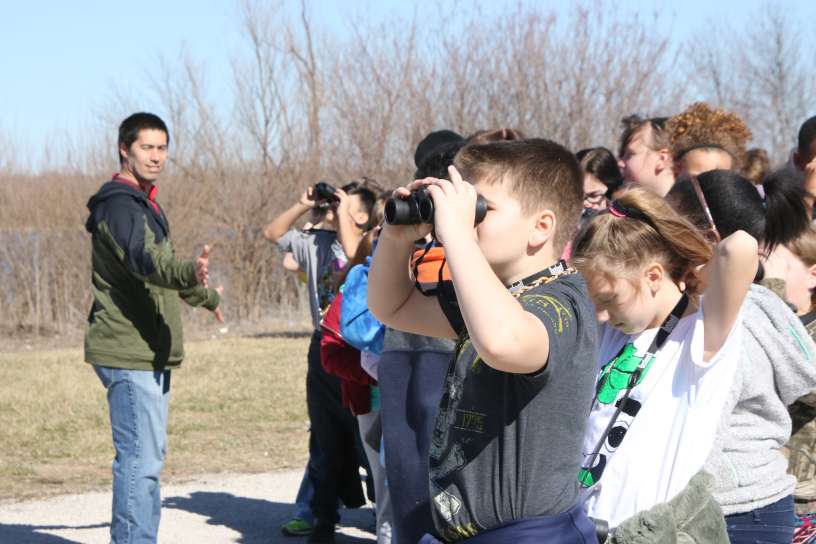 birdwatching children looking through binoculars