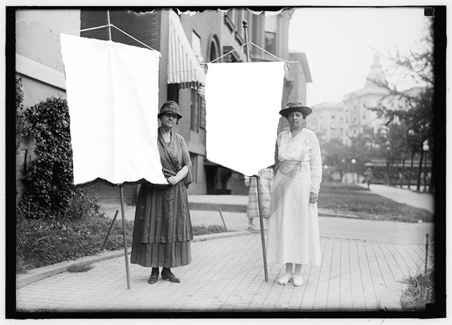 photo of 2 Sufferagettes with blank banners